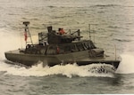 A PTF Nasty-class patrol boat underway near Little Creek, Virginia, circa early 1970s. The Nasty-class of fast patrol boats ran in shallow water, were equipped with a .50 caliber and were purchased for operations during the Vietnam War. The Combatant Craft Division militarized and ruggedized them in preparation for use in the Vietnam War. (U.S. Navy photo provided by John “Jack” Mathias)