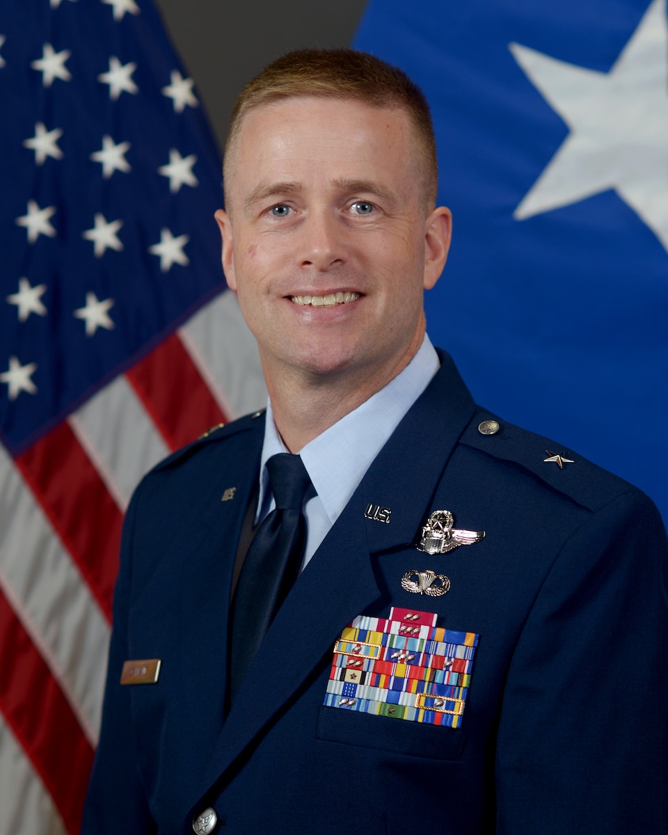photo of Brig. Gen. Randy P. Oakland in front of flags.
