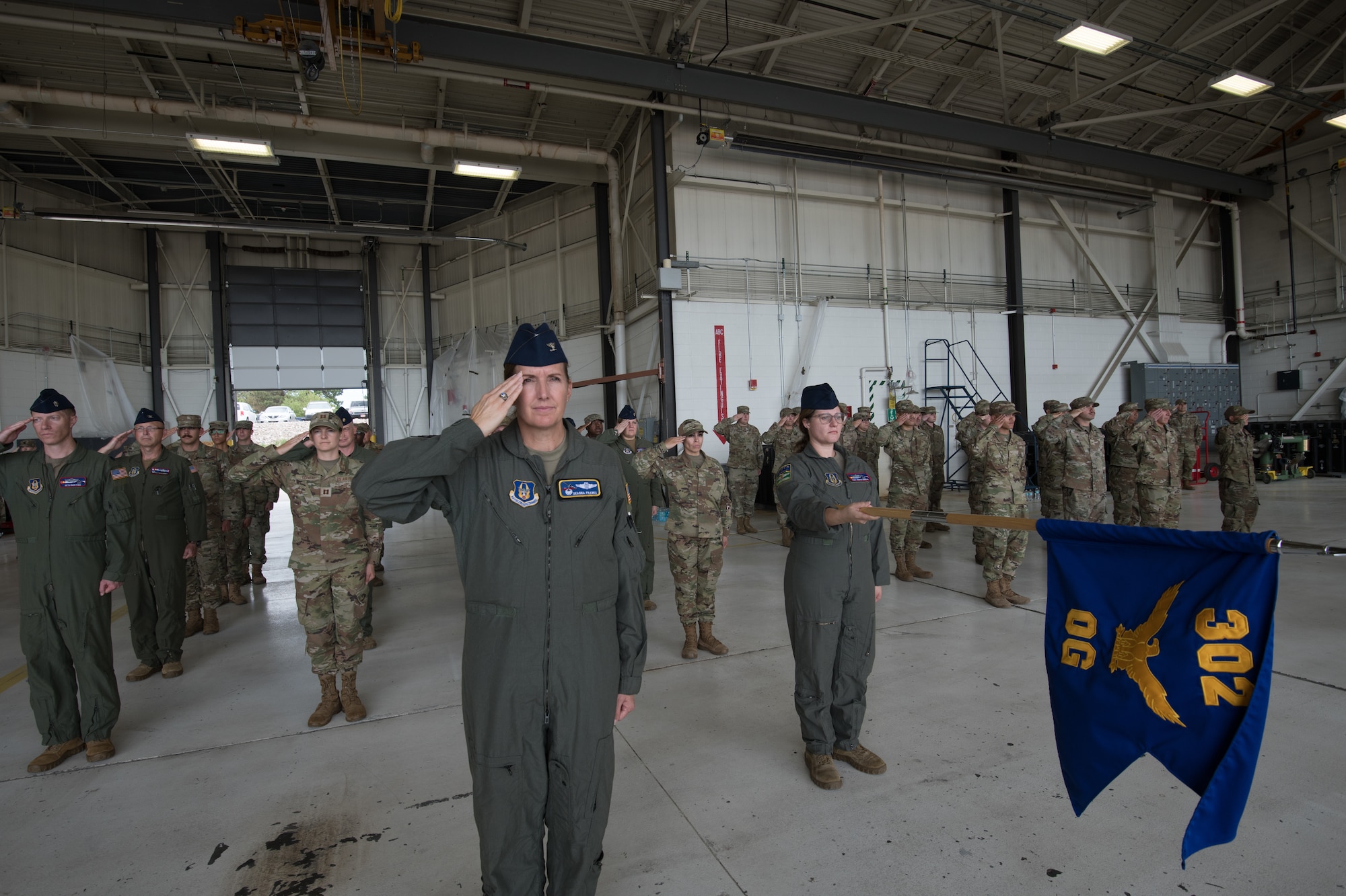 Airmen salute in formation.