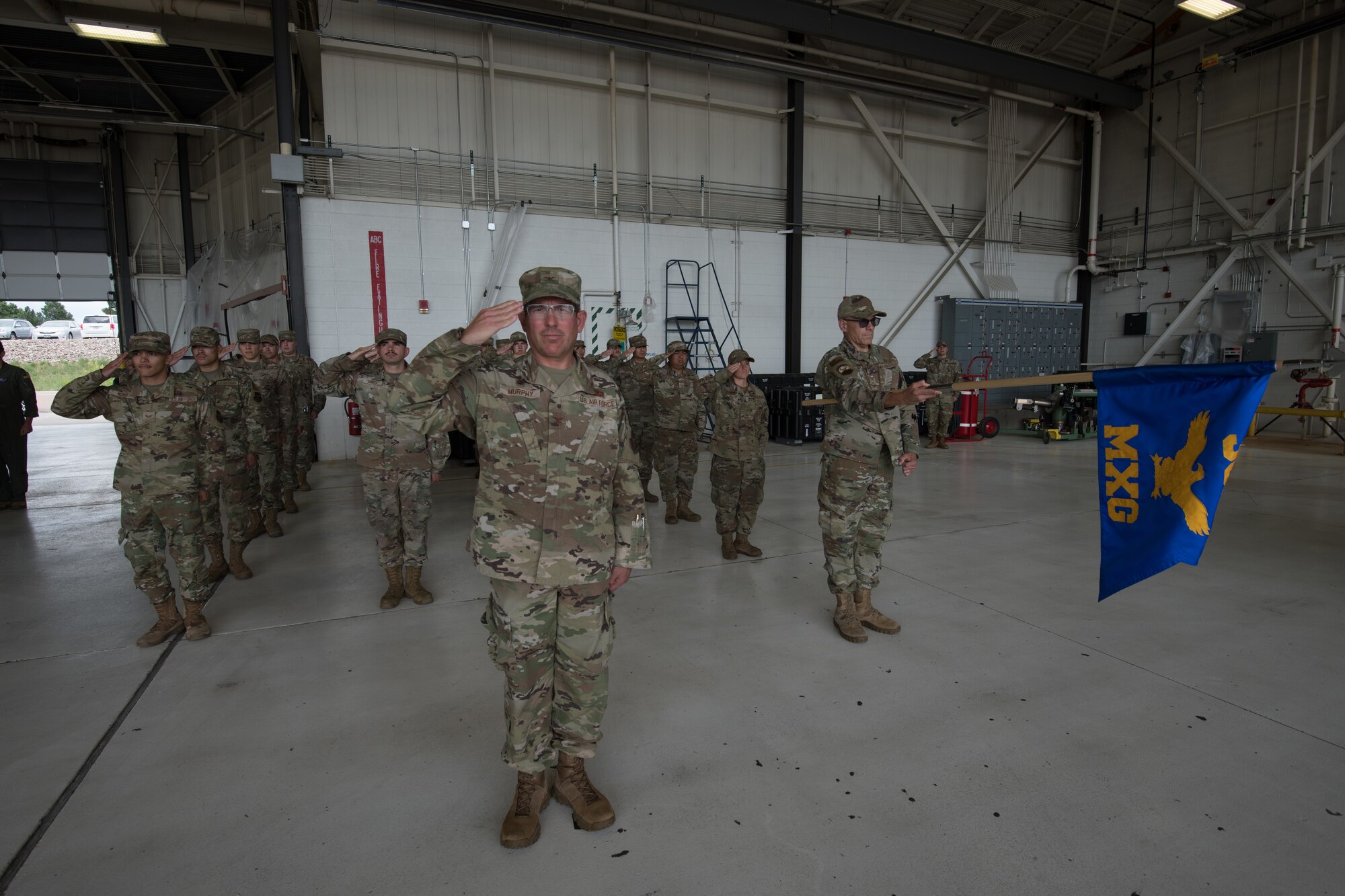 Airmen salute in formation.