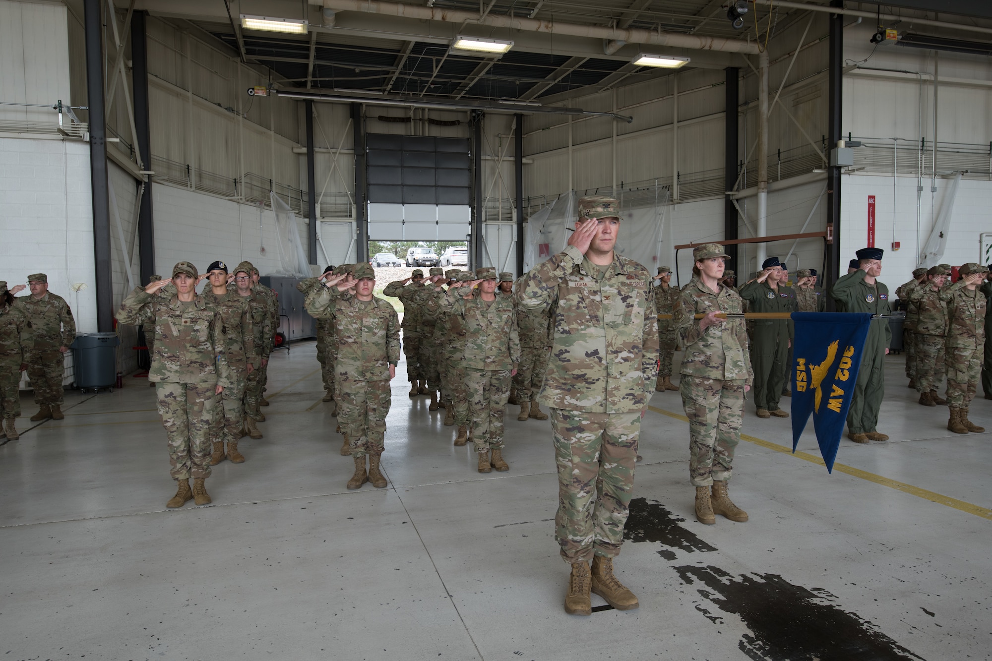 Airmen salute in formation.
