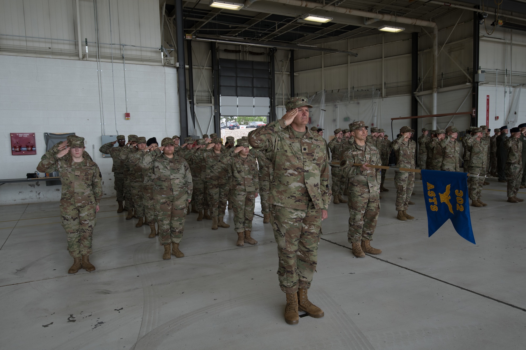 Airmen salute in formation.