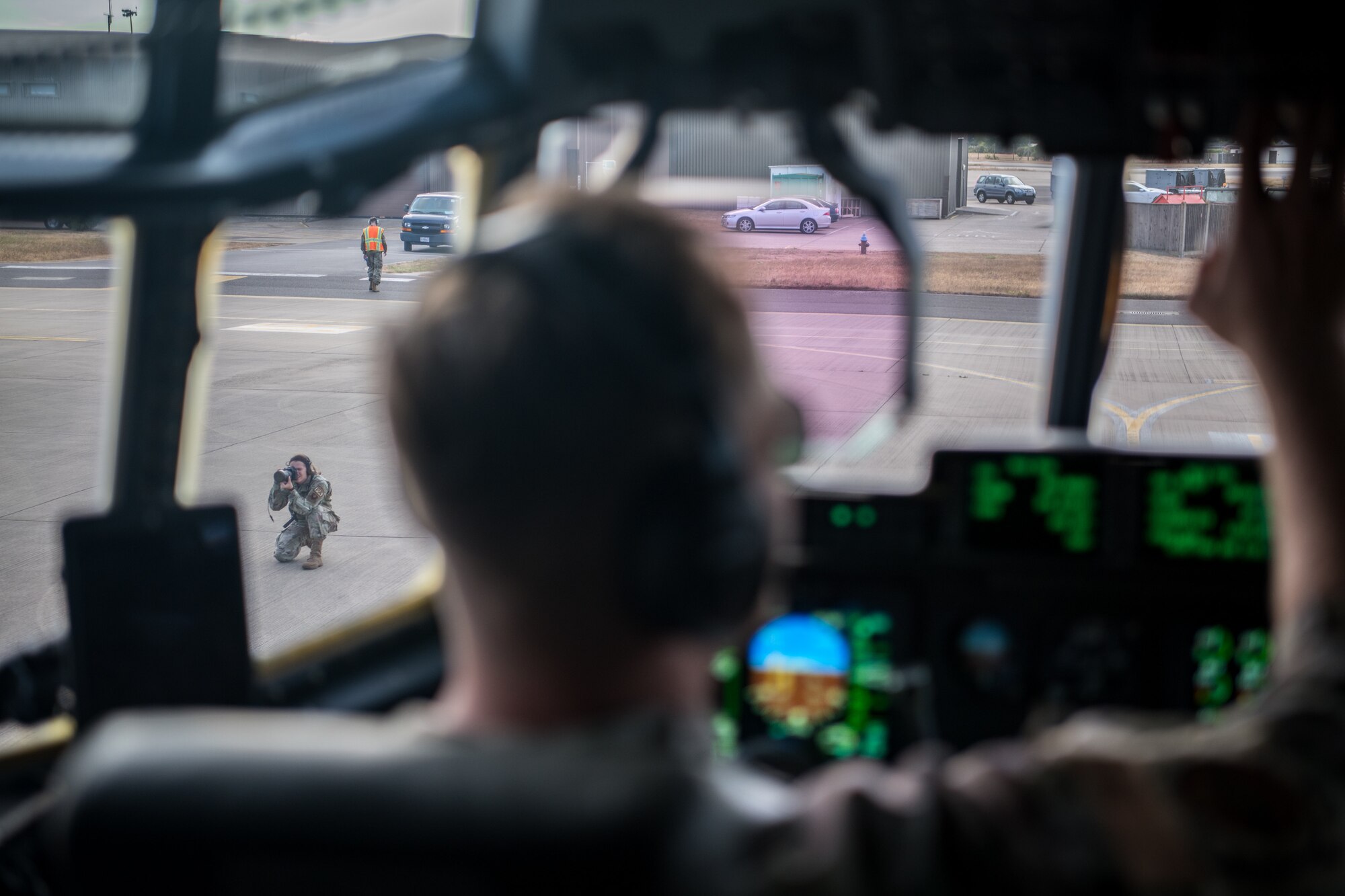person takes photos while pilot readies aircraft