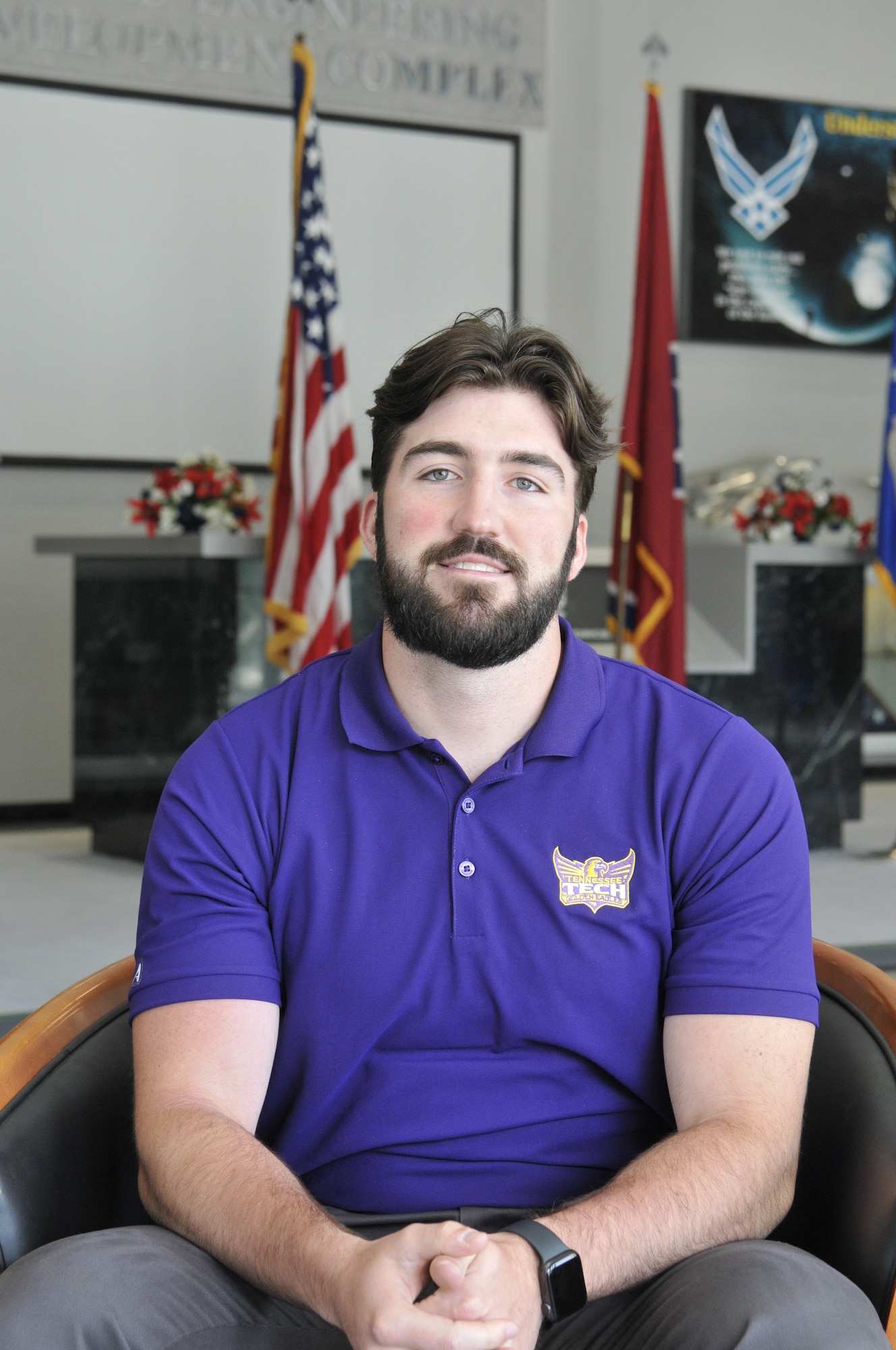 Zachary Collins, engineer intern at Arnold Engineering Development Complex, looks at the camera for the photo while sitting in a chair in the lobby of the Administration and Engineering Building at Arnold Air Force Base, Tenn.