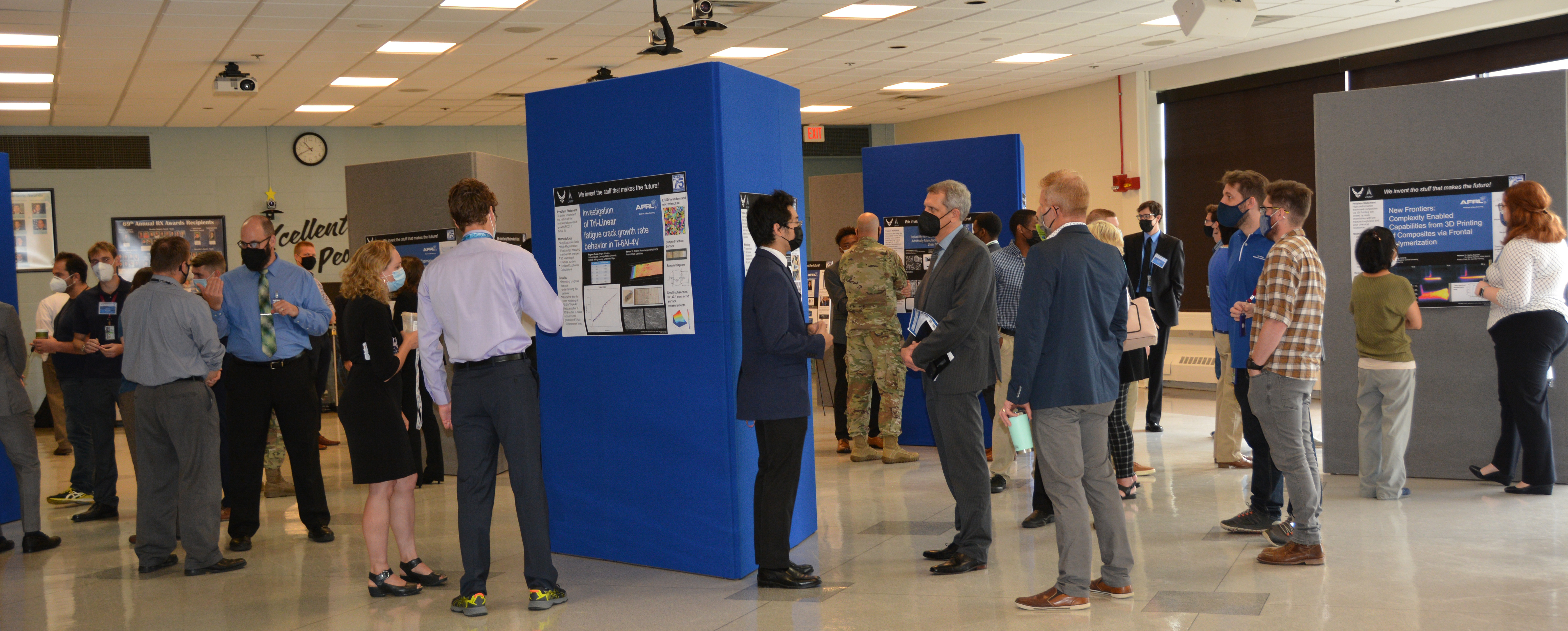 Crowd of students, leaders and peers present their research experiments Aug. 4, 2022, to the public the Student Poster Session A 2022 in the cafetorium of building 653. Students present new technologies and findings from their summer internships.