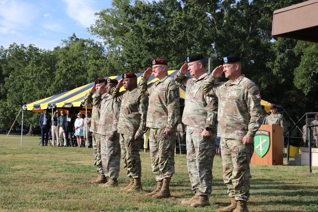 The official party at the U. S. Army Civil Affairs and Psychological Operations Command (AIRBORNE) joint Change of Command, Change of Responsibility, Retirement Ceremony salute during the presentation of the colors on the main parade field, Ft. Bragg, NC., August 13, 2022. (U.S. Army Reserve photo by Pfc. Anthony Till)