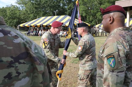 Retiring commanding general, Maj. Gen. Jeffrey Coggin, passes the U.S. Army Civil Affairs and Psychological Operations Command (AIRBORNE) colors to Maj. Gen. Michael D. Roache, U.S. Army Reserve Command chief of staff, during the USACAPOC(A) joint Change of Command, Change of Responsibility, Retirement Ceremony held at the main post parade field, Ft. Bragg, NC., August 13, 2022. (U.S. Army Reserve photo by Pfc. Anthony Till)