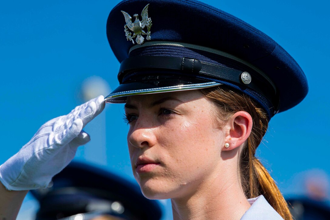 An Air Force cadet salutes.