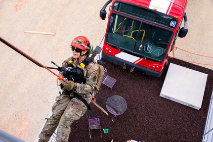 U.S. Air Force Tech Sgt. Holly McLelland, a medic with the 151st Air Refueling Wing, Utah National Guard, rappels down the side of a building as part of search-and-extraction training on the new Collapsed Structure Venue Site during a Region VIII Homeland Response Force readiness evaluation exercise at Camp Williams, Utah, August 3-7, 2022.