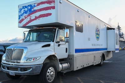 Mobile dental unit van parked pier-side.