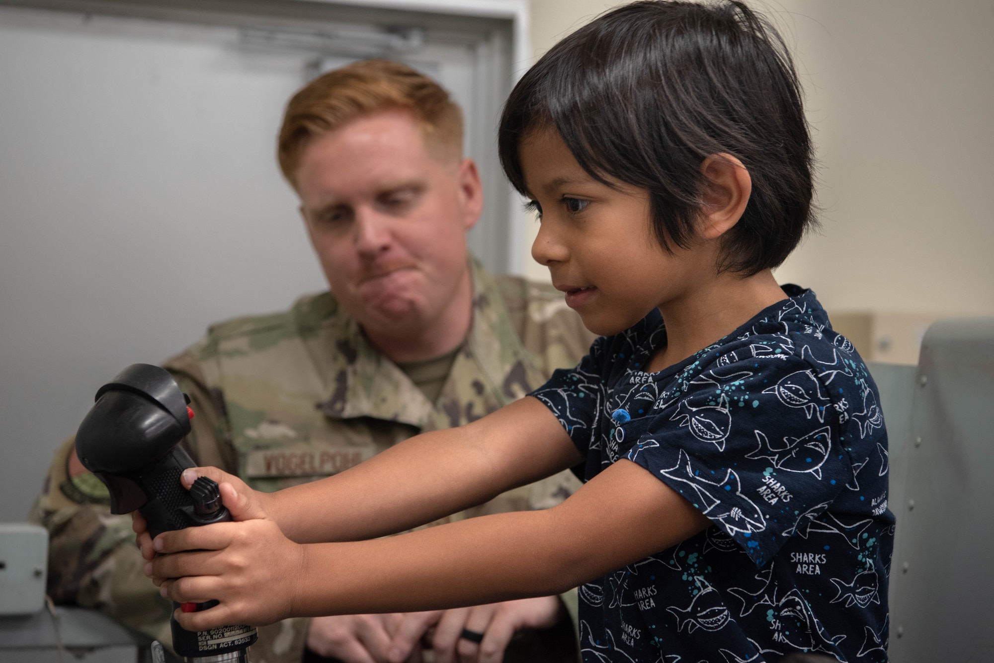 A student uses the control stick on a training system.