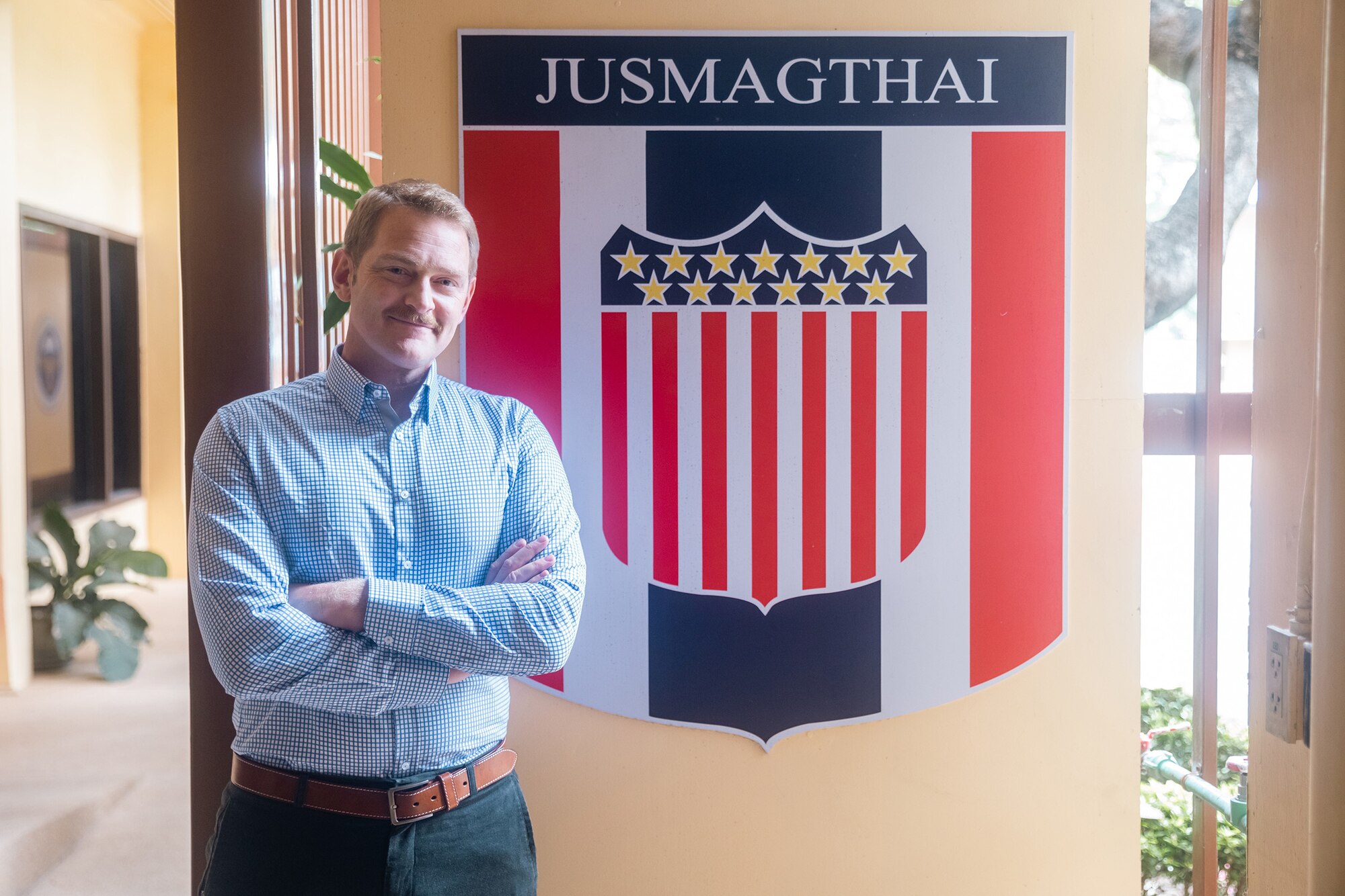 Maj. Joel Johnson, Bilateral Affairs Officer in the Kingdom of Thailand standing in front of the Joint US Military Advisory Group-Thailand (JUSMAGTHAI) sign at the headquarters in Bangkok, Kingdom of Thailand on August 7, 2022.