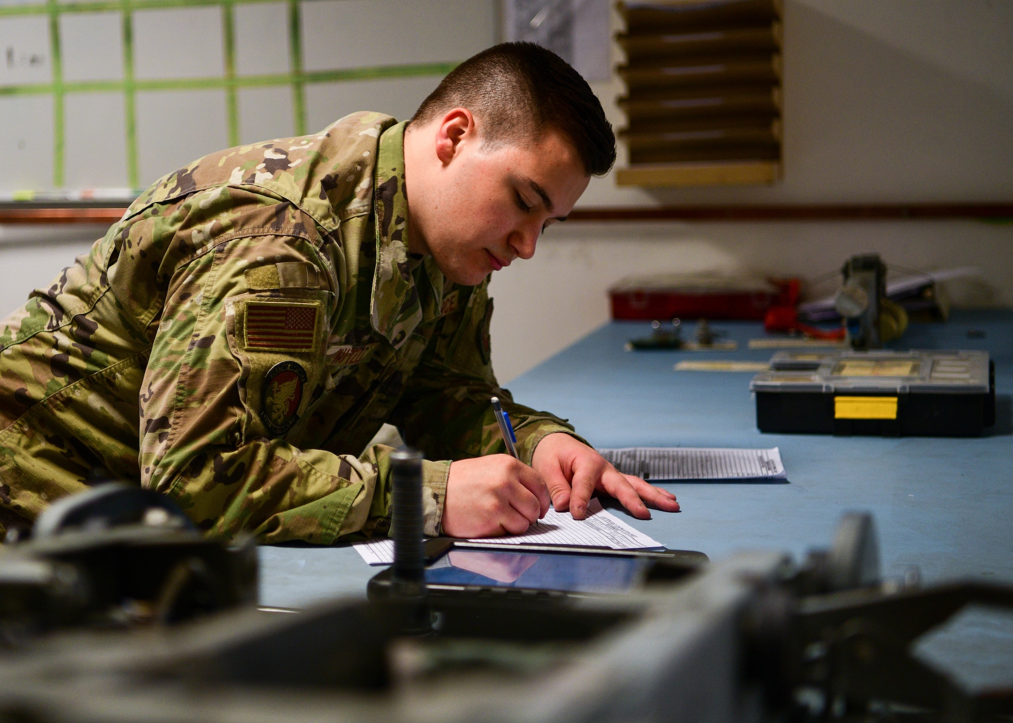 Senior Airman Reece Kutzli, 31st Maintenance Squadron Egress journeyman, logs equipment during an inspection at Aviano Air Base, Italy, Aug. 10, 2022. During inspections, the specialists check the canopy’s components for safety, security and serviceability. (U.S. Air Force photo by Senior Airman Brooke Moeder)