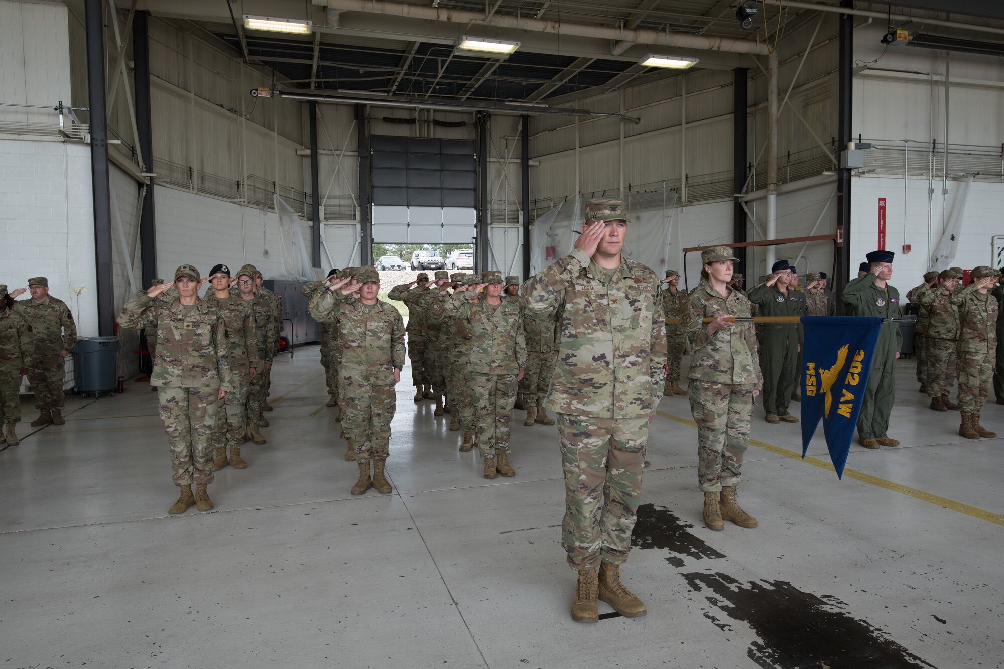 Airmen salute in formation.