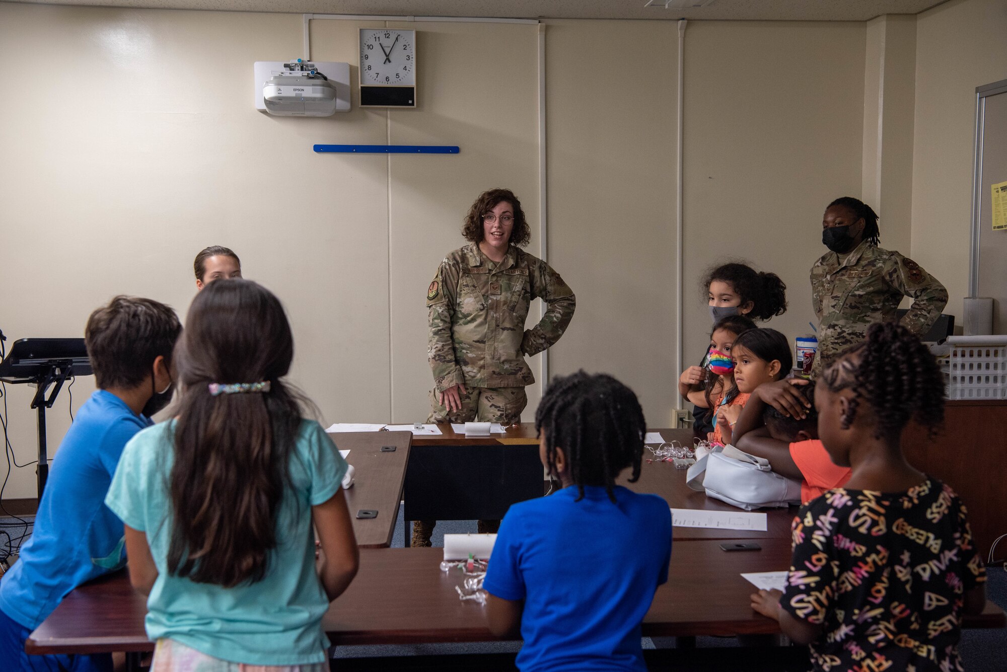 An Airman gives a presentation to a group of students.