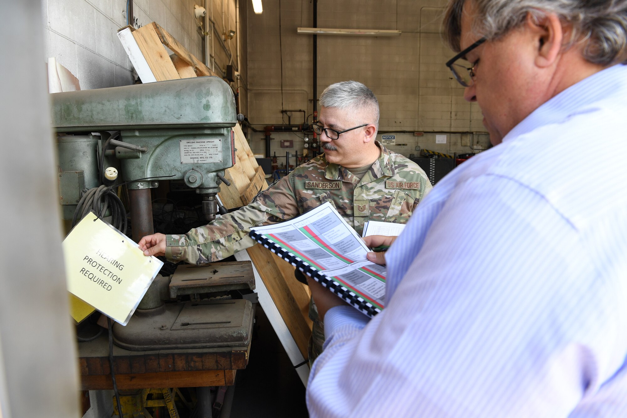 Airman and civilian perform safety inspection