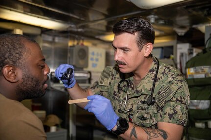 Hospital Corpsman 1st Class Jacob Jeffreys simulates a routine medical checkup on a sailor aboard the Freedom-class littoral combat ship USS Sioux City (LCS 11) while pierside.