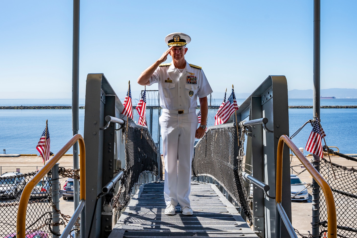 Vice Adm. Daniel Dwyer, commander, U.S. 2nd Fleet, boards the USS Hornet Sea, Air and Space Museum during the 100th Anniversary of the Aircraft Carrier ceremony in Alameda, Calif., Aug. 13.