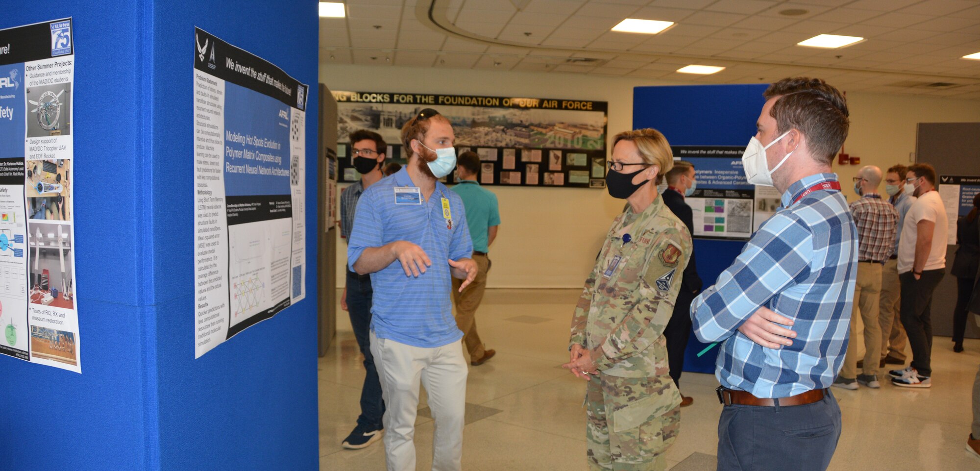 Maj. Gen. Heather Pringle, Air Force Research Laboratory commander, center, visits a student poster presentation Aug. 4, 2022, in building 653 at Wright-Patterson Air Force Base, Ohio. The student interns from AFRL’s Materials and Manufacturing Directorate presented their research experiments to the public at the Student Poster Session A 2022.