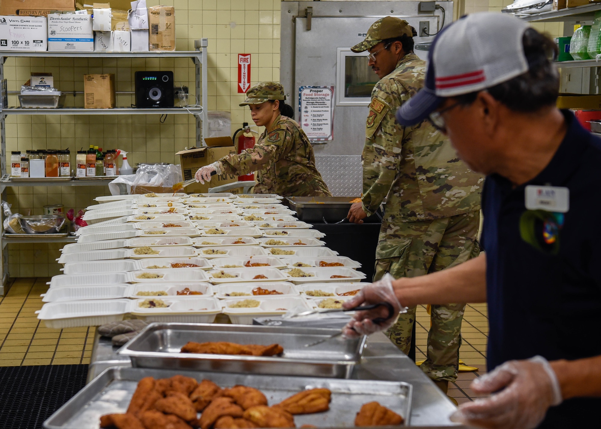 U.S. Air Force Senior Airman Alicia Gullory, food service member with the 36th Force Support Squadron, fills food containers at Andersen Air Force Base, Guam, Aug 2, 2022. Gullory was preparing meals for the U.S. National Guardsmen who were actively involved in an exercise on base. (U.S. Air Force photo by Airman 1st Class Allison Martin)