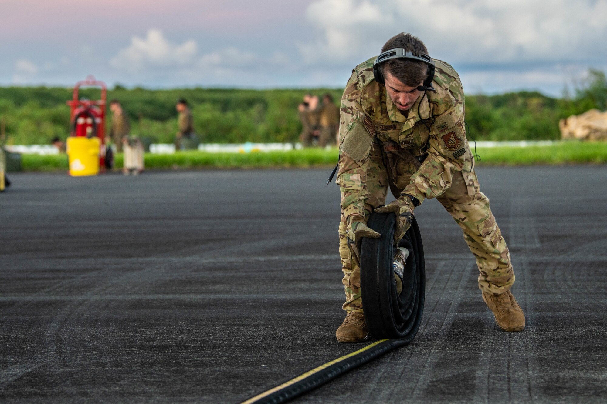 An Airman rolls a fuel hose after a fuel off-load