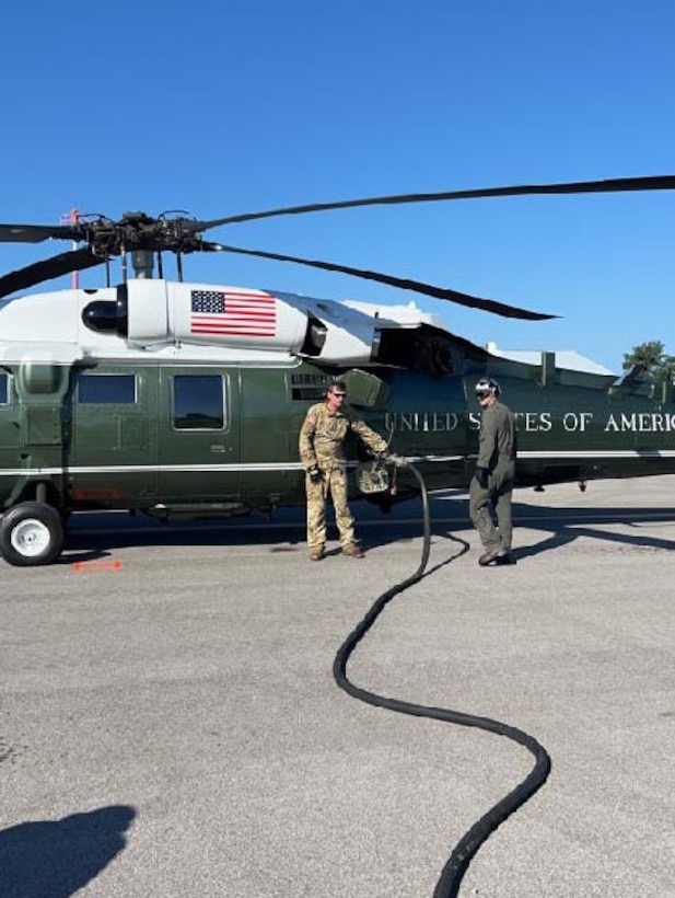 Army Sgt. William ‘Cecil’ Harris, a fuel Supply specialist with Detachment 1, Carlie Co. 2-238th Aviation- ‘Wildcat DUSTOFF’ refuels the presidents Sikorsky VH-60 helicopter, Marine One, while it sits on the ground in Hazard, Ky., Aug 7, 2022