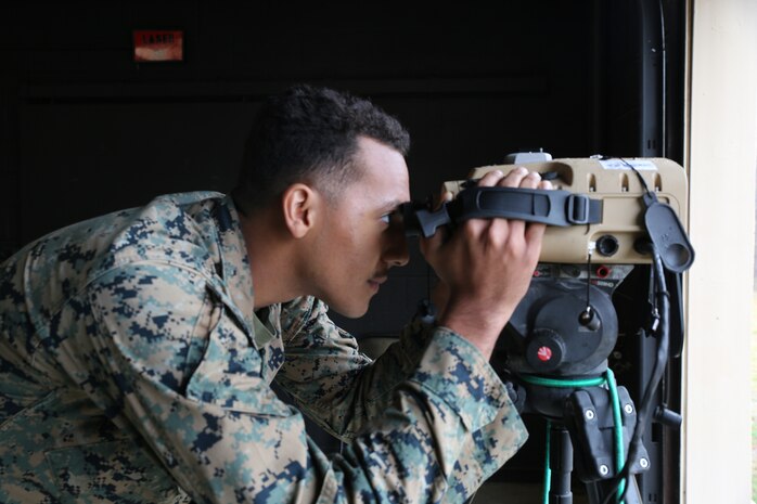 Lance Cpl. Dwight Amos peers through a prototype version of the Next-Generation Handheld Targeting System, March 2021 at U.S. Army Garrison Fort A.P. Hill, Virginia. The Next-Generation Handheld Targeting System, or NGHTS, is an innovative, man-portable targeting system allowing Marines to rapidly and accurately conduct target location and laser guidance during combat operations.
