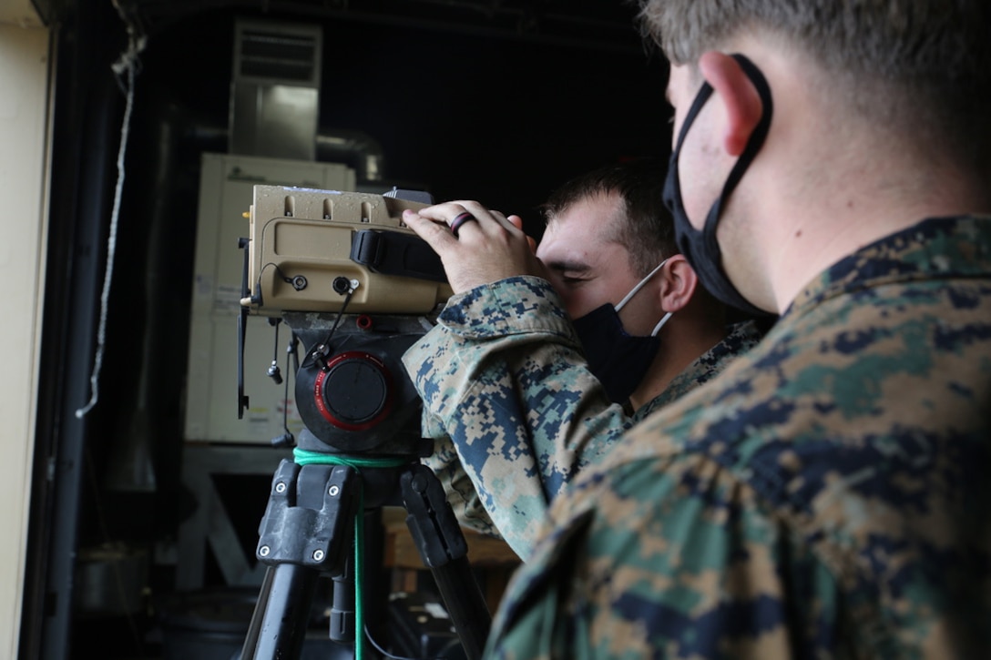 Marines peers through a prototype version of the Next-Generation Handheld Targeting System, March 2021 at U.S. Army Garrison Fort A.P. Hill, Virginia. The Next-Generation Handheld Targeting System, or NGHTS, is an innovative, man-portable targeting system allowing Marines to rapidly and accurately conduct target location and laser guidance during combat operations.