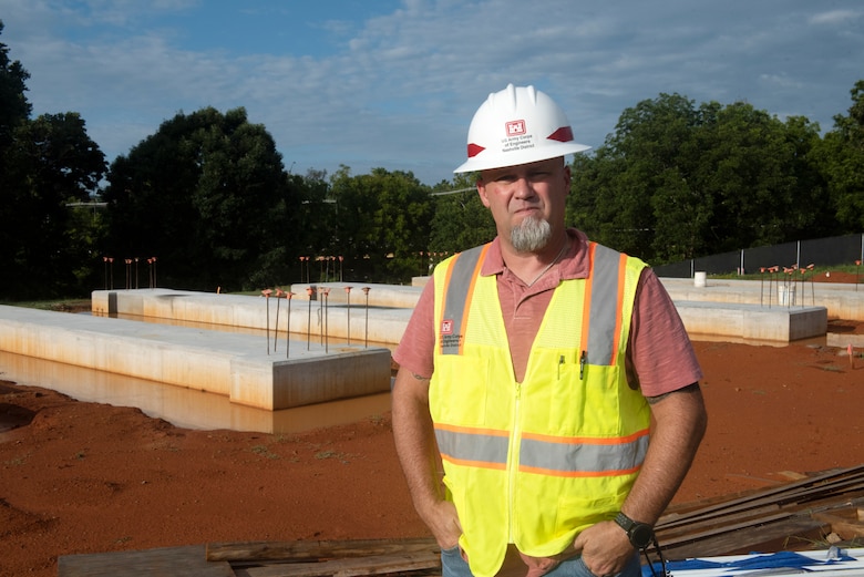 Nathan Alford, engineer technician and construction representative in the Nashville District’s Eastern Tennessee Resident Office in Knoxville, poses Aug. 10, 2022, next to columbarium foundations that will provide 3,140 niches for veteran internments at Mountain Home National Cemetery in Johnson City, Tennessee. (USACE Photo by Lee Roberts)