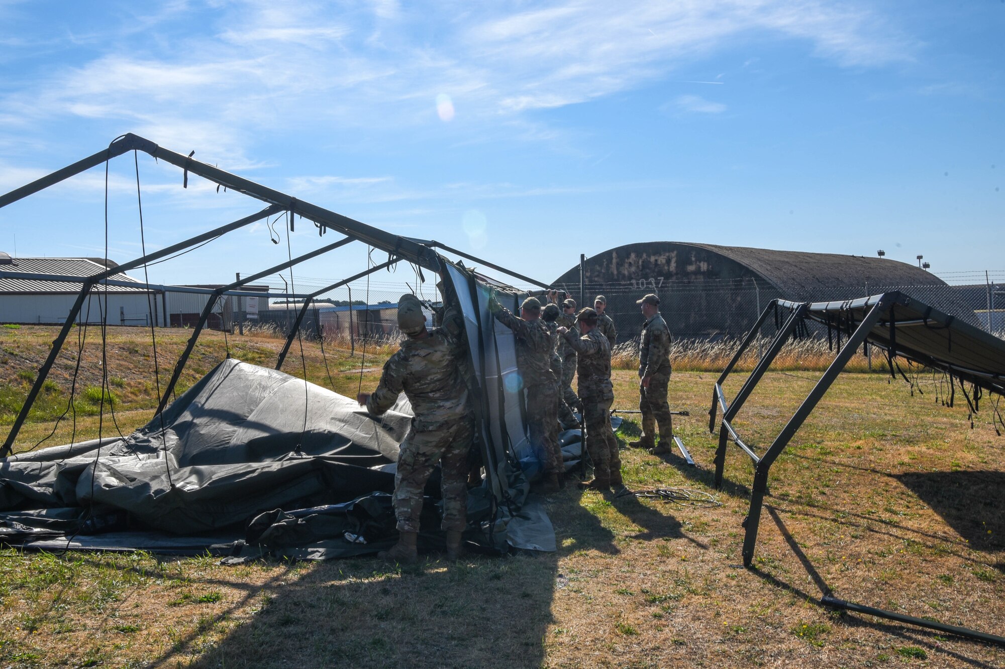 Service members build a Project Arcwater tent.