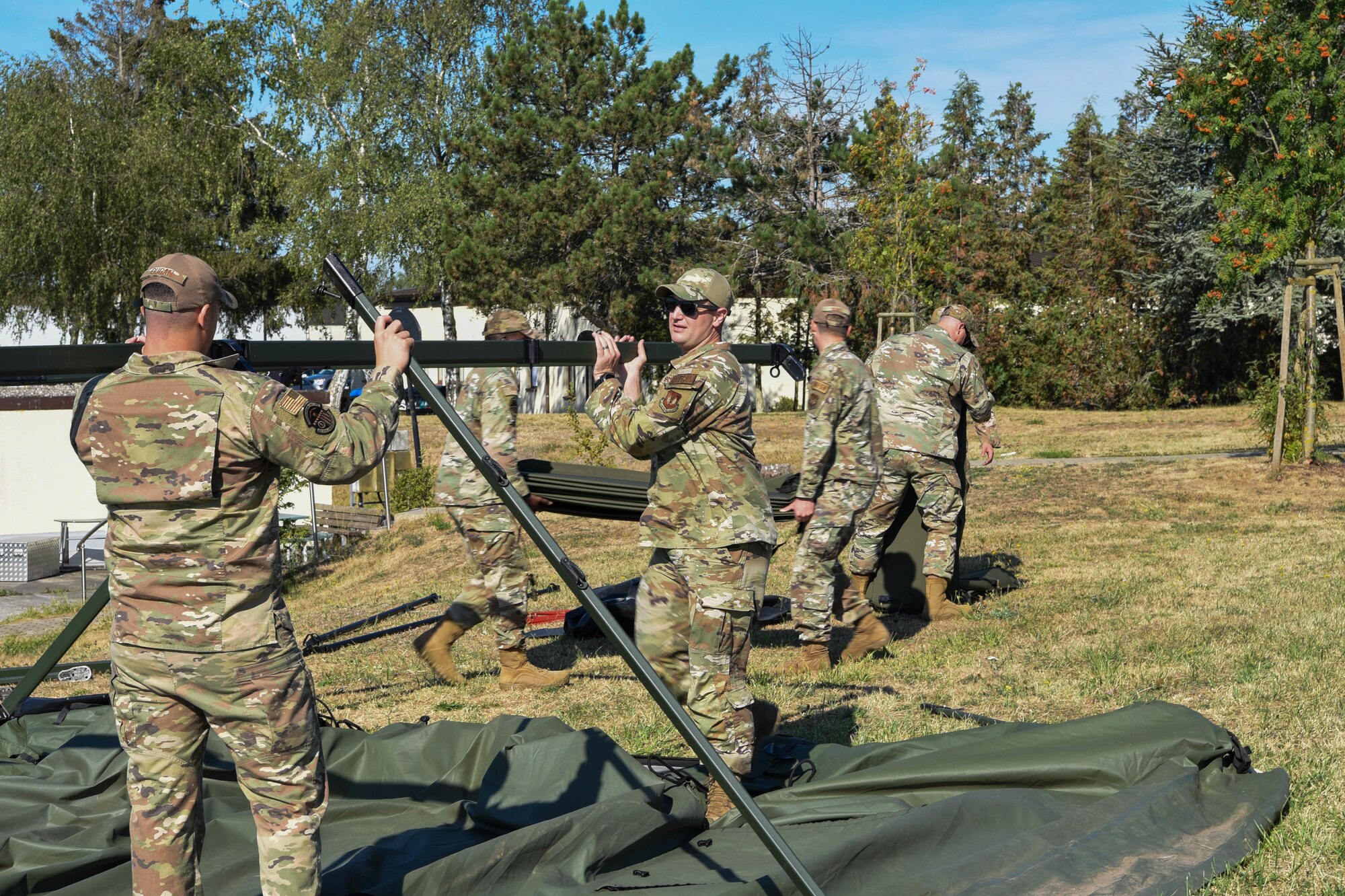 Service members build a Project Arcwater tent.