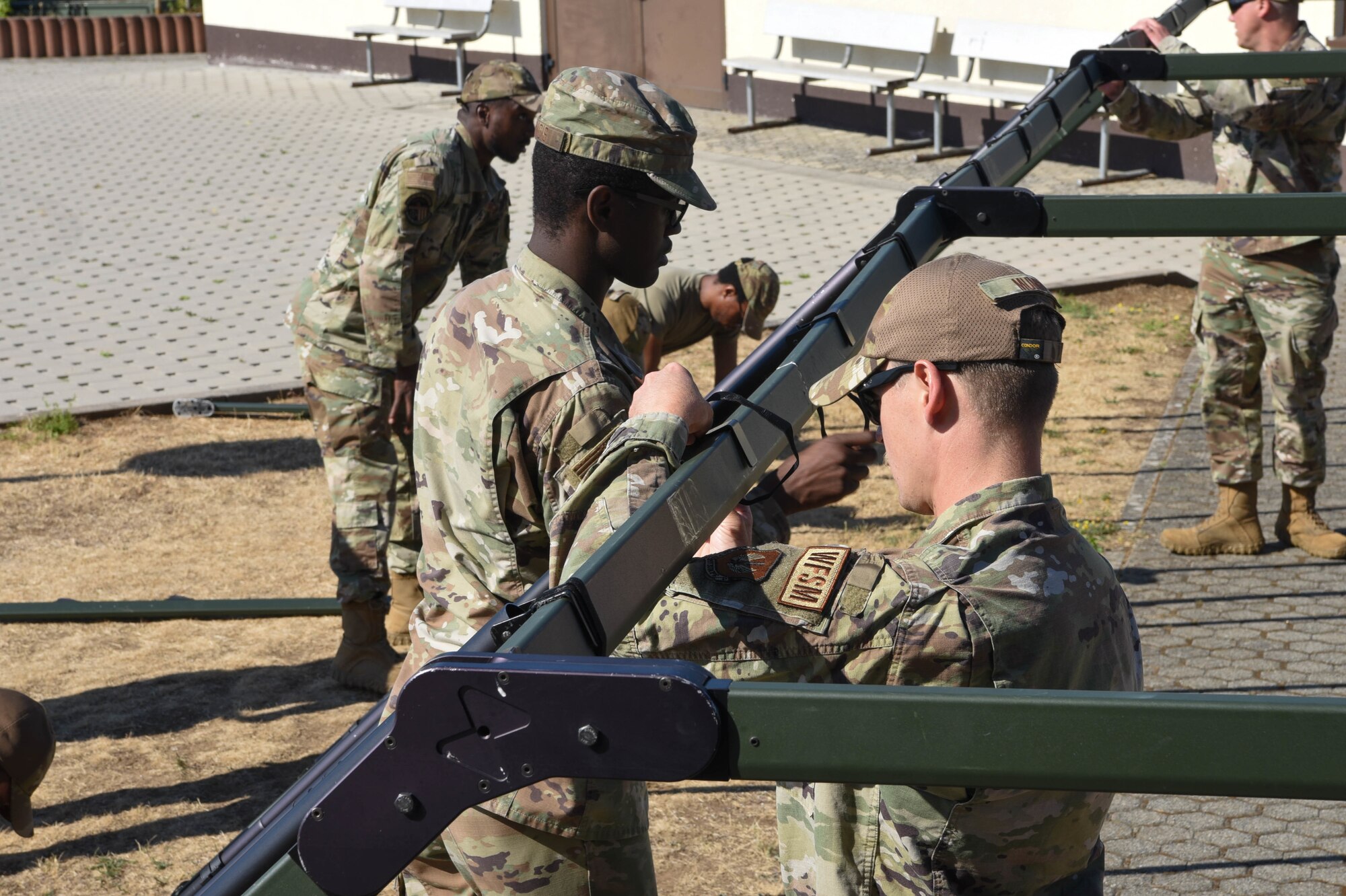 Service members build a Project Arcwater tent.