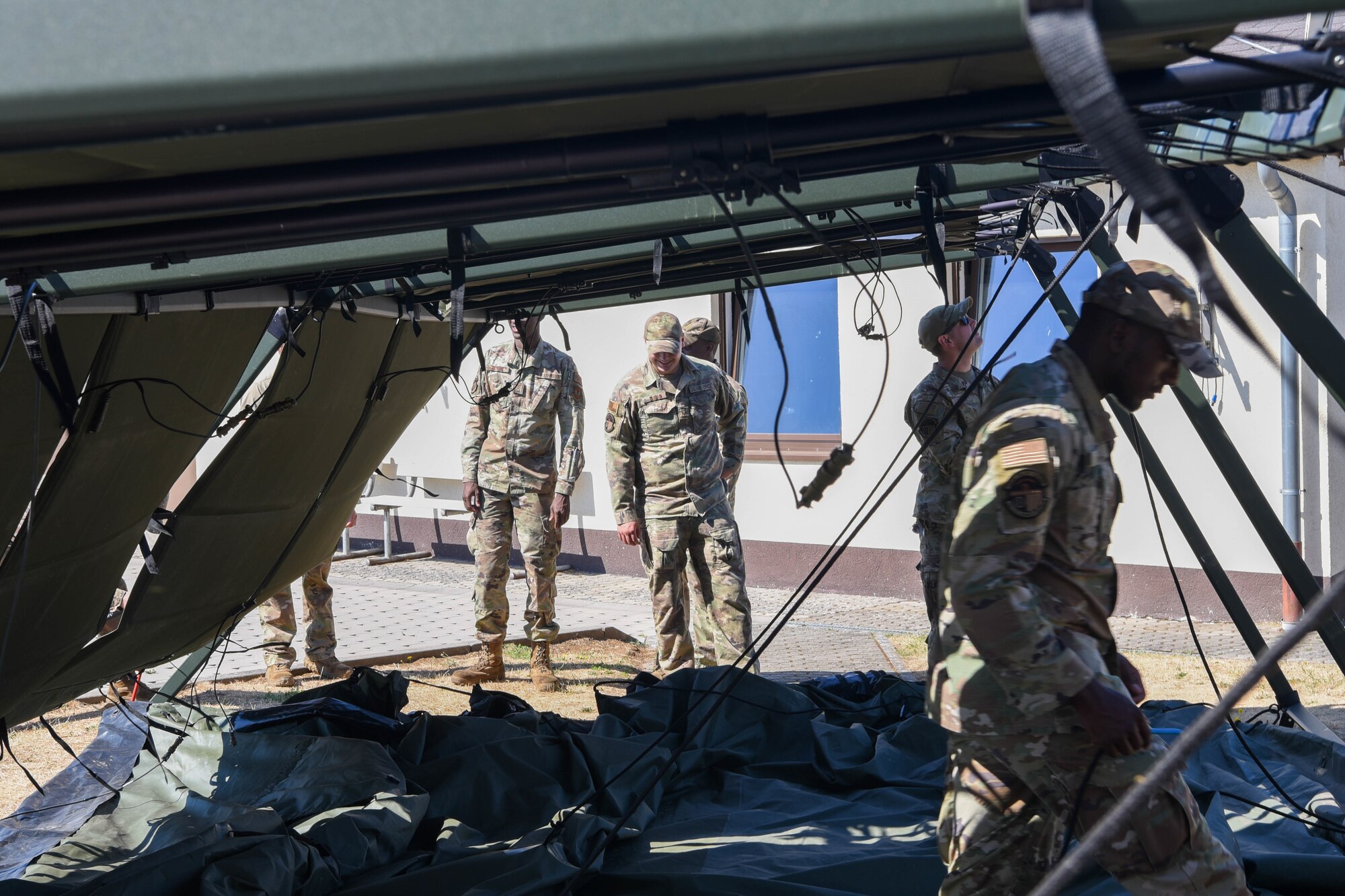 Service members build a Project Arcwater tent.