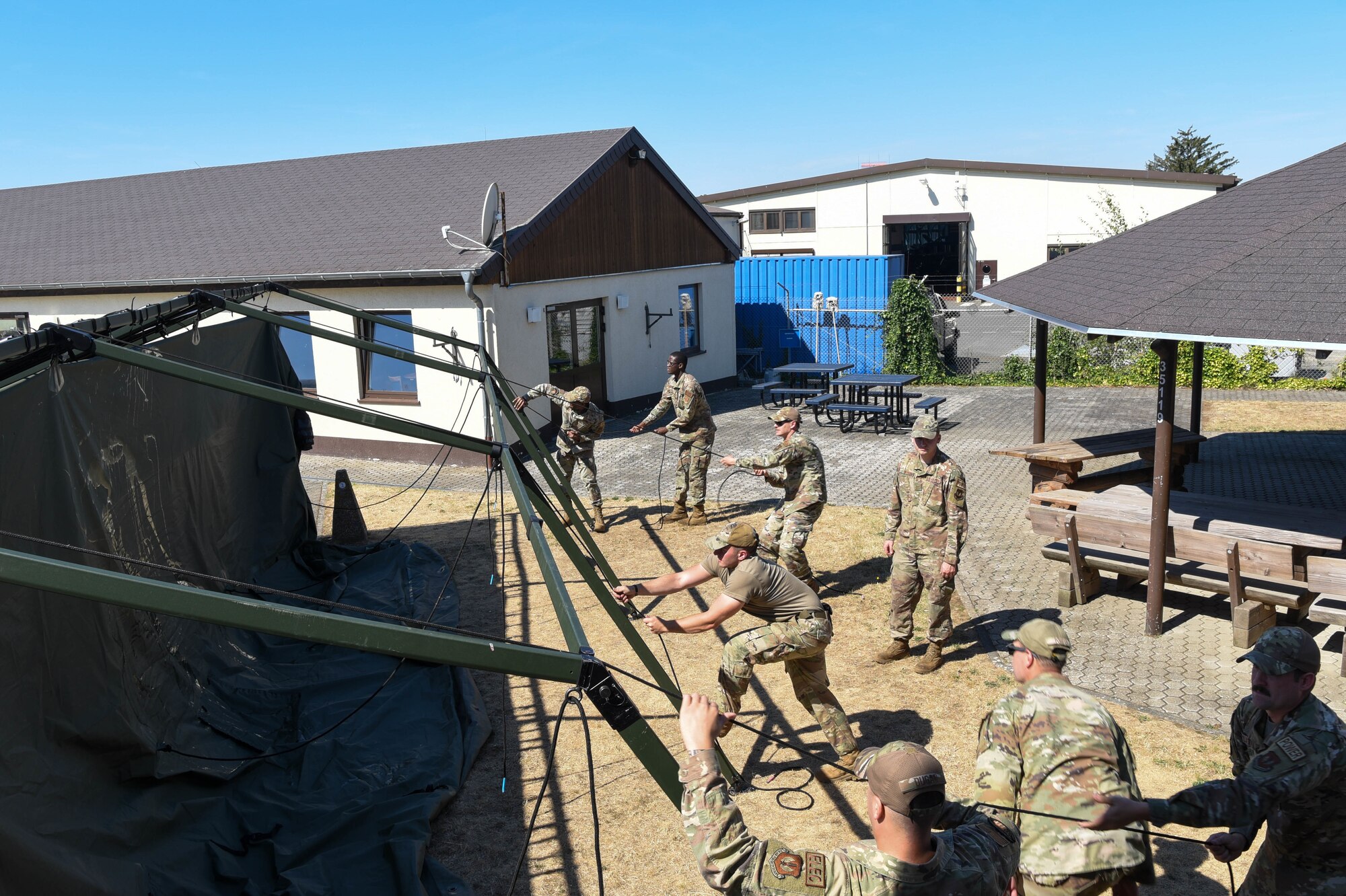Service members build a Project Arcwater tent.