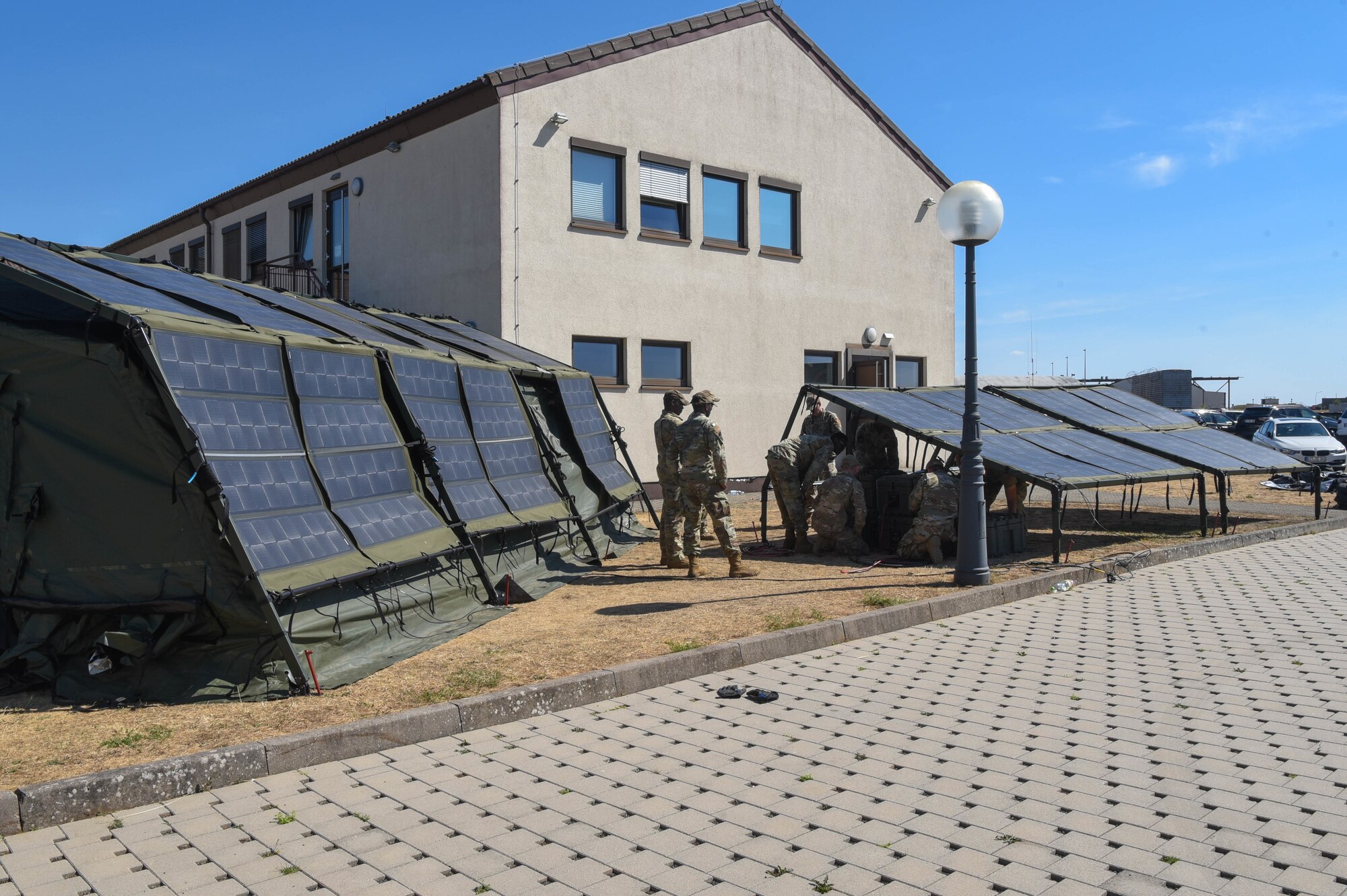 Service members build a Project Arcwater tent.