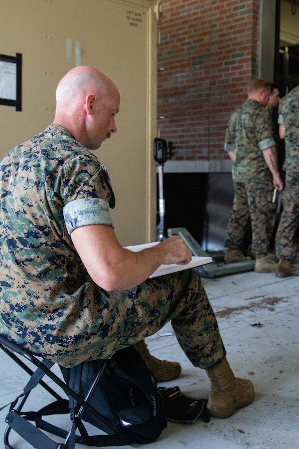Capt. Michael Reynolds, ammunition officer with Marine Forces Special Operations Command, sketches Marine Raiders receiving a concept of operations brief prior to a pre-deployment culminating exercise at Camp Lejeune, N.C., June 13-16, 2022. Reynolds joined Capt. Charles Bauman, a combat artist and logistics officer with Marine Wing Support Squadron 271, to document MARSOC training for his application for the Marine Corps Combat Art Program. Combat artist is a free military occupational specialty that can be filled by any Marine regardless of primary military occupational specialty in addition to their regular duties. They illustrate military operations on behalf the Marine Corps’ historical collection efforts. (U.S. Marine Corps photo by Capt. Charles J. Baumann)