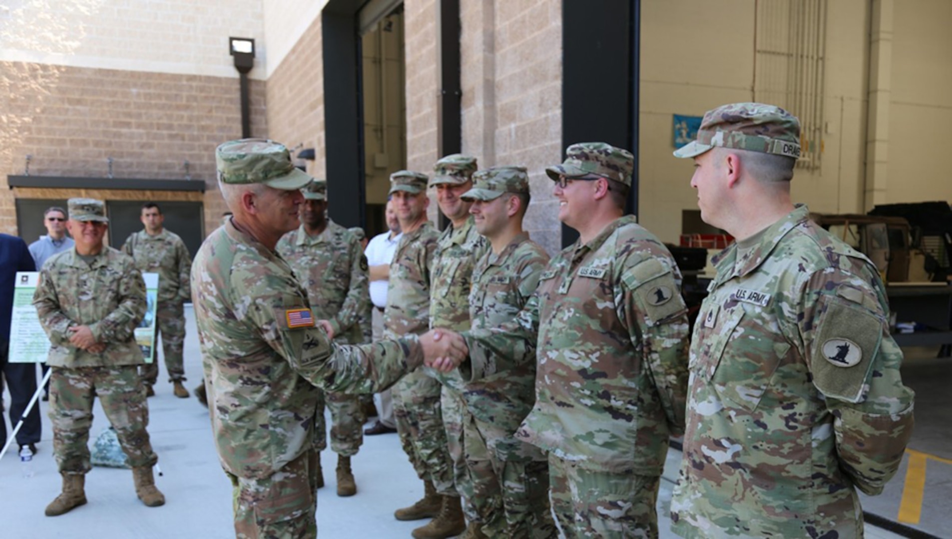 Maj. Gen. Anthony Potts, program executive officer for Command, Control, Communications-Tactical (PEO C3T), thanks and provides a PEO C3T coin to Soldiers from the Delaware Army National Guard 198th Expeditionary Signal-Battalion for their extraordinary efforts during the new equipment training and fielding for the modernized ESB-E equipment set, in New Castle, Delaware, on August 9, 2022.