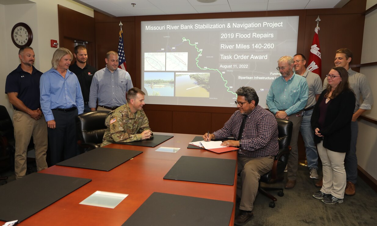 A group of Kansas City District workers associated with navigation repairs to the Missouri River join David Best, team lead and contracting officer for the civil contracting branch, and Col. Travis Rayfield, commander, to discuss the signing of the Multiple Award Task Order Contract – known as a MATOC – accounting for $27 million in repairs to river training structures on the river, Aug. 16, 2022.