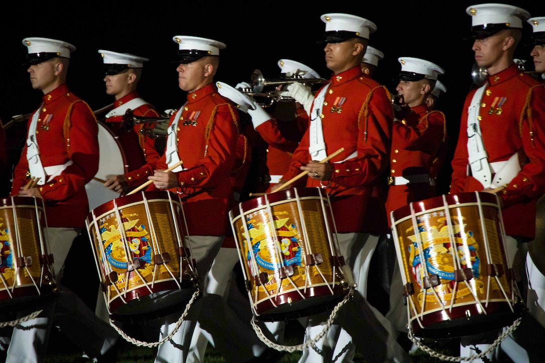 Marines play drums during a parade.