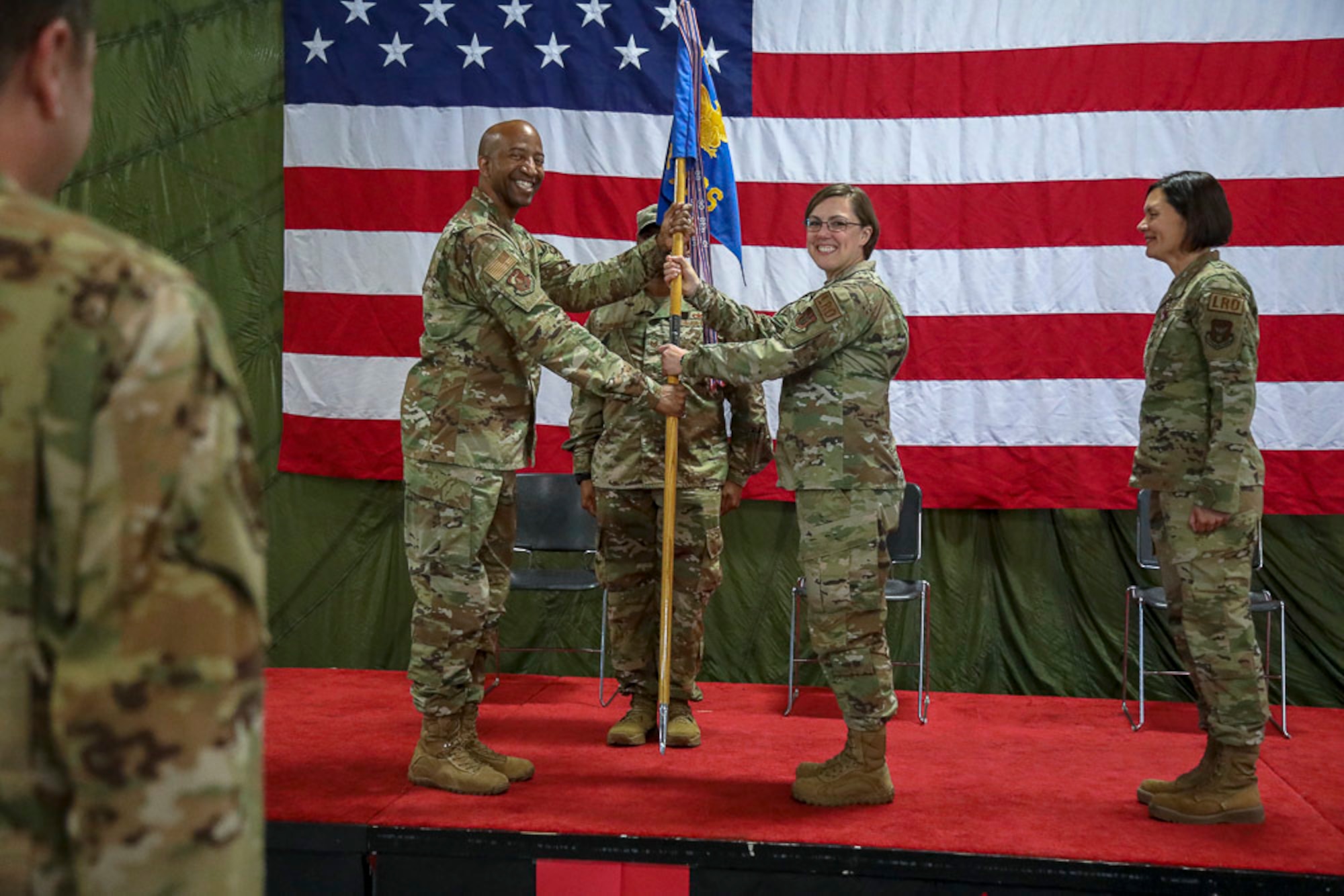 Col. Dorroh smiles as he passes the 86th Aerial Port Squadron guidon to Lt. Col. Tara Horton, the new commander during a change of command ceremony.