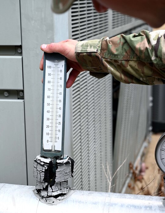 a man checks a temperature gauge