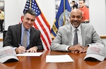 IMAGE: Naval Surface Warfare Center Dahlgren Division (NSWCDD) Technical Director Dale Sisson Jr., SES, and University of the District of Columbia (UDC) President Ronald Mason sign an Educational Partnership Agreement. The partnership provides NSWCDD support to the university while developing a future talent pool for the Navy from UDC students who are pursuing STEM-related degrees.