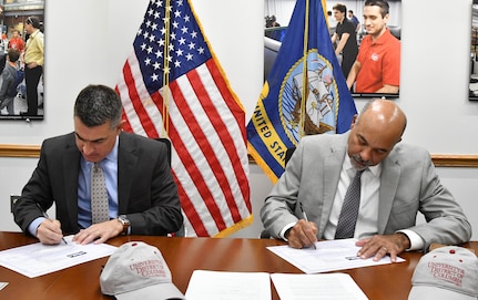 IMAGE: Naval Surface Warfare Center Dahlgren Division (NSWCDD) Technical Director Dale Sisson Jr., SES, and University of the District of Columbia (UDC) President Ronald Mason sign an Educational Partnership Agreement. The partnership provides NSWCDD support to the university while developing a future talent pool for the Navy from UDC students who are pursuing STEM-related degrees.