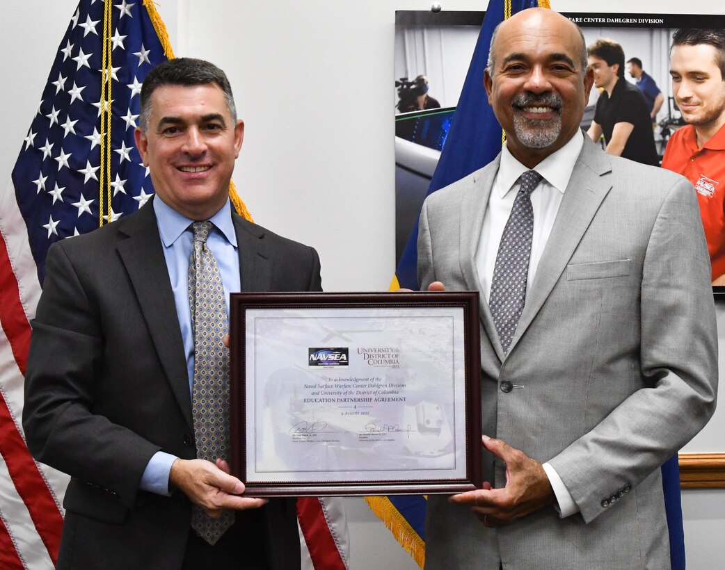 IMAGE: Naval Surface Warfare Center Dahlgren Division (NSWCDD) Technical Director Dale Sisson Jr., SES, and University of the District of Columbia (UDC) President Ronald Mason display the newly-signed Education Partnership Agreement Aug. 9. The partnership provides NSWCDD support to the university while developing a future talent pool for the Navy from UDC students who are pursuing STEM-related degrees.