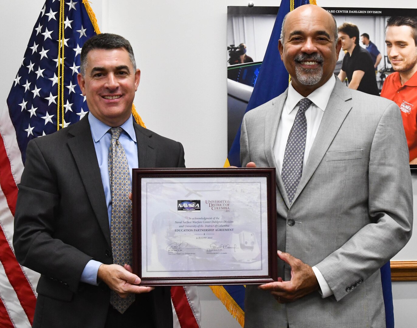 IMAGE: Naval Surface Warfare Center Dahlgren Division (NSWCDD) Technical Director Dale Sisson Jr., SES, and University of the District of Columbia (UDC) President Ronald Mason display the newly-signed Education Partnership Agreement Aug. 9. The partnership provides NSWCDD support to the university while developing a future talent pool for the Navy from UDC students who are pursuing STEM-related degrees.