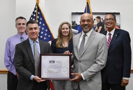 IMAGE: Naval Surface Warfare Center Dahlgren Division (NSWCDD) Technical Director Dale Sisson Jr., SES, and University of the District of Columbia (UDC) President Ronald Mason display the Education Partnership Agreement, signed Aug. 9. The partnership provides NSWCDD support to the university while developing a future talent pool for the Navy from UDC students who are pursuing STEM-related degrees. Pictured with them from left to right in the back row, are NSWCDD’s Deputy Technical Director Darren Barnes and Chief Technology Officer Jennifer Clift and UDC Vice President for Research Dr. Victor McCrary.