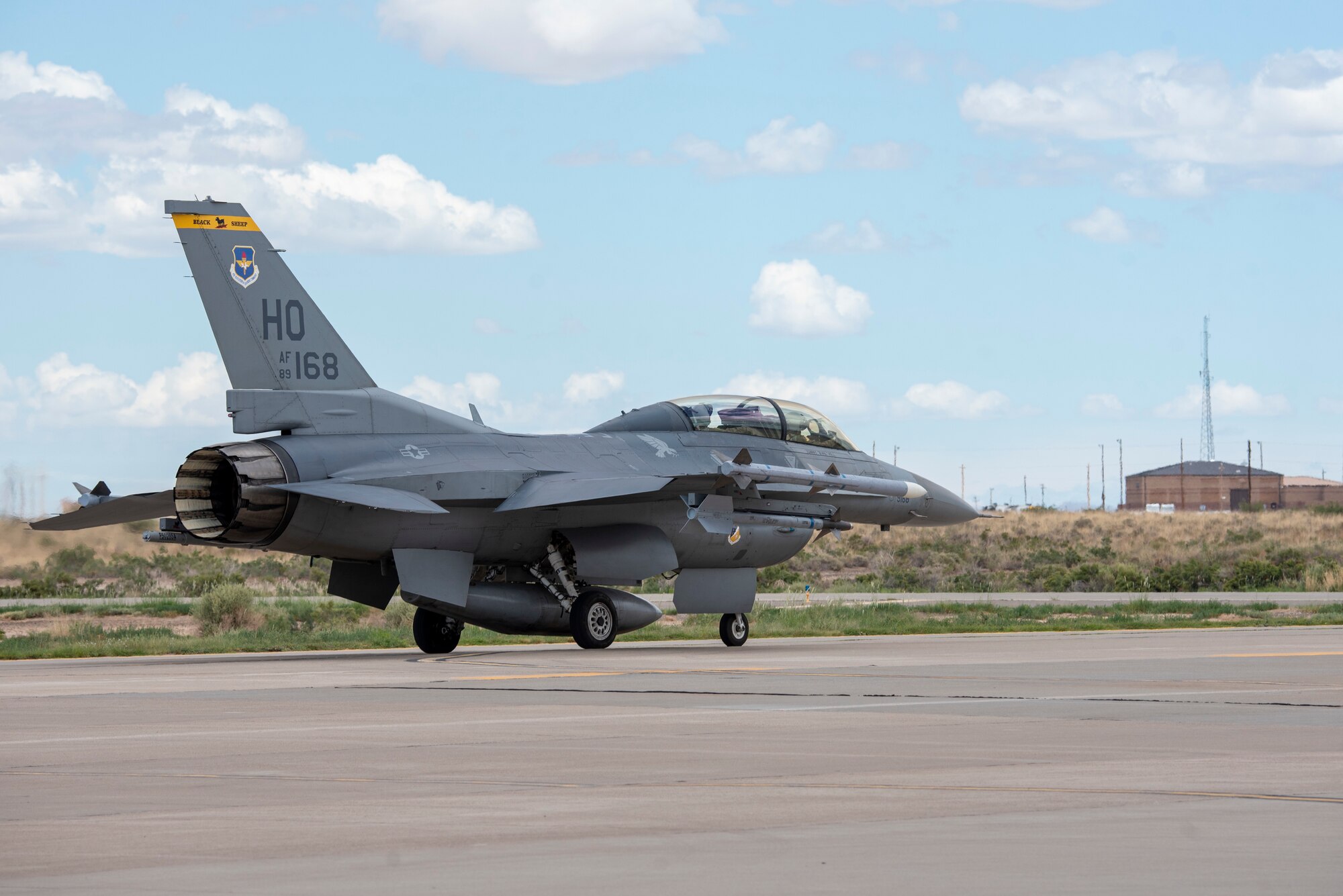 A grey F-16 Viper piloted by Colonel Justin Spears and Major Michael McCann is taxied on a runway.