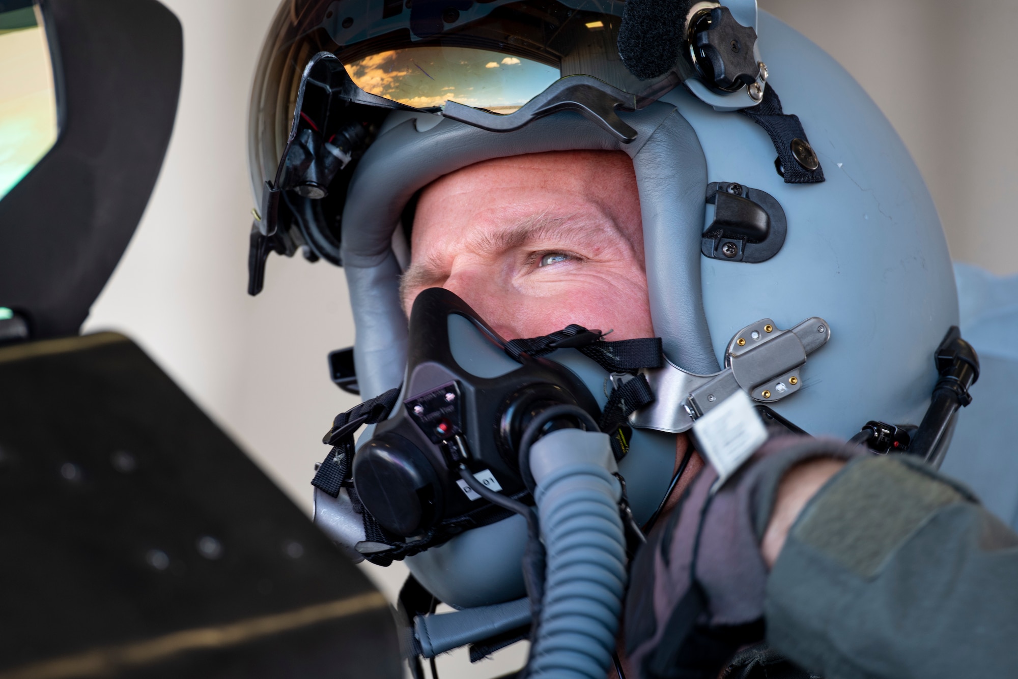 Colonel Justin Spears, 49th Wing Commander secures his grey pilot helmet.