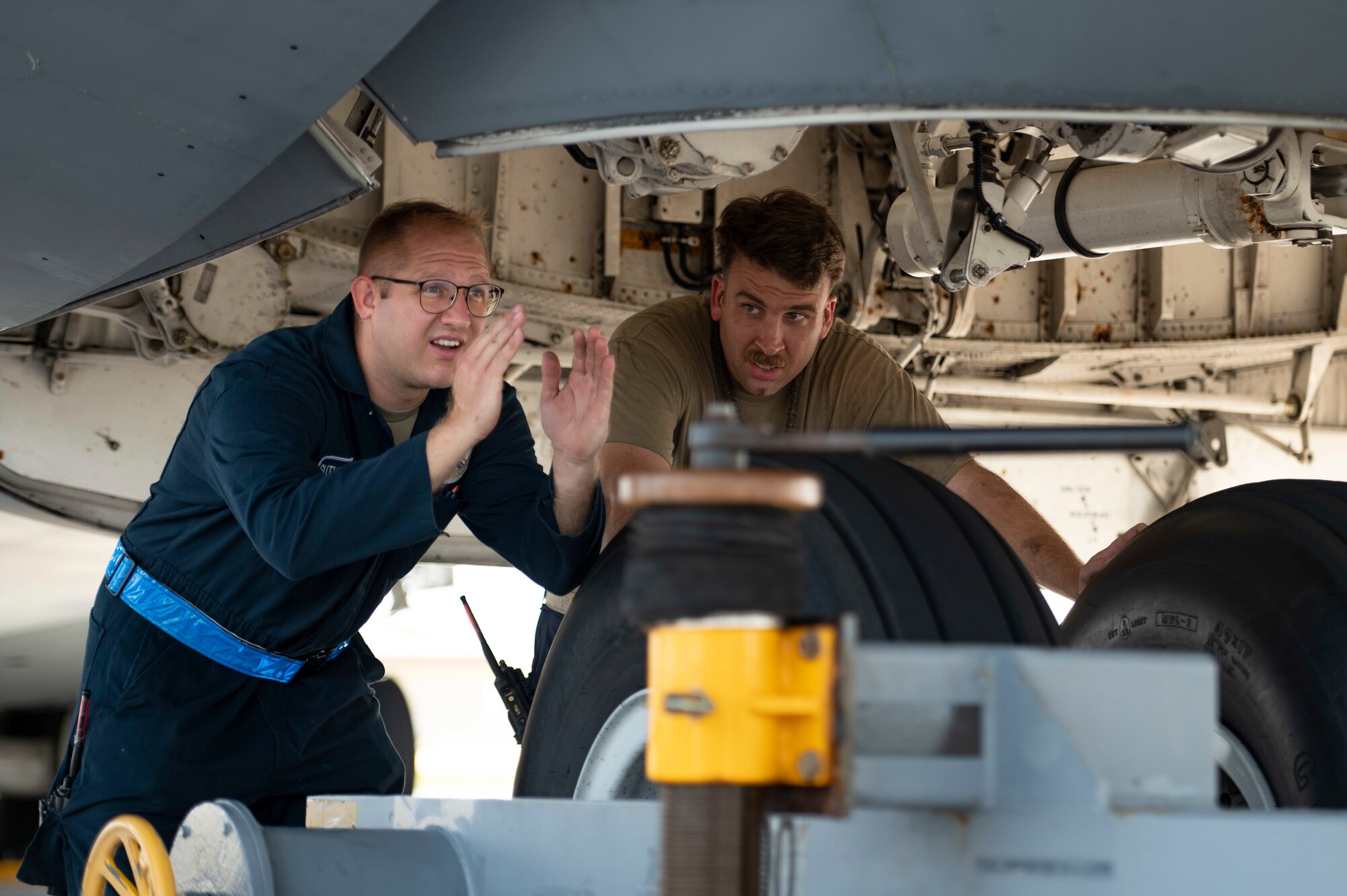 U.S. Air Force Airmen assigned to the 734th Air Mobility Squadron, Andersen Air Force Base, Guam, prepare to tow a U.S. Air Force C-5M Super Galaxy, July 13, 2022 at Andersen AFB. A team of instructors assigned to the 515th Air Mobility Operations Wing, Joint Base Pearl Harbor-Hickam, Hawaii, trained Airmen assigned to Andersen AFB on aircraft towing, jacking, and air force specialty code specific training. During this training, Airmen not specifically assigned to the C-5 received training and familiarization of the systems and capabilities of the aircraft. (U.S. Air Force Photo by Airman 1st Class Emily Saxton)