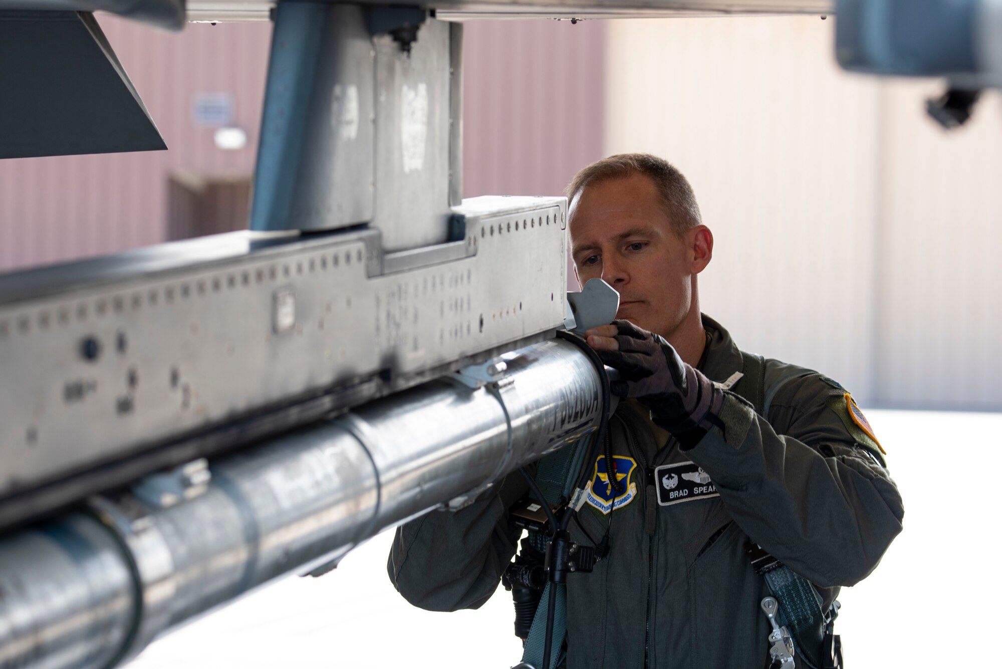 Colonel Justin Spears does a pre-flight check on an F-16 Viper.